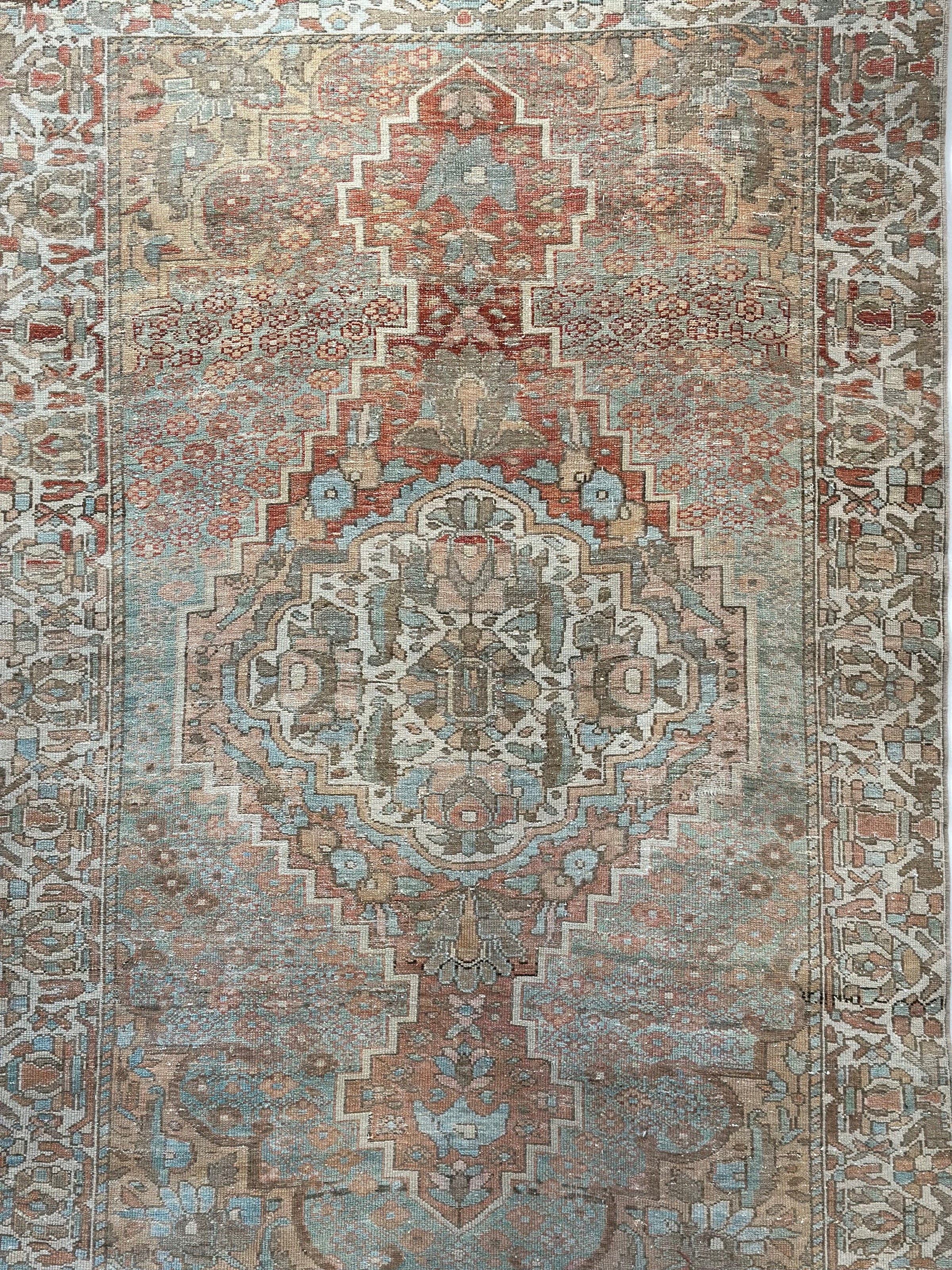 Vintage Persian rug with intricate patterns.